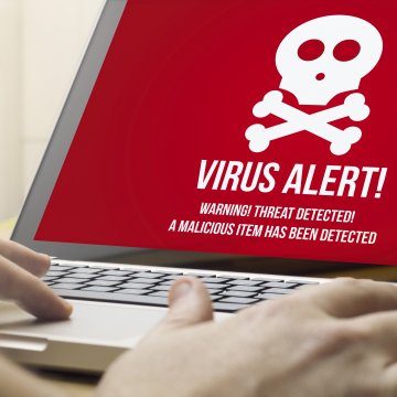 bitdefender antivirus plus 2020 security software red virus alert on monitor display on laptop hands typing
